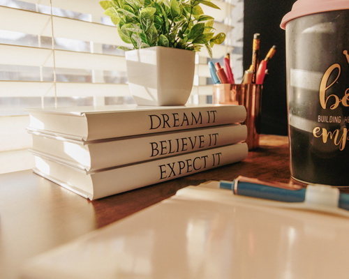 dream it, believe it, expect it books stacked in a row